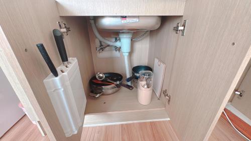 a small kitchen with a sink and a counter top at Garden in Jeju 201 in Seogwipo