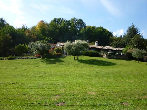 a field with trees and a house in the background at Country House Barone D'Asolo in Asolo