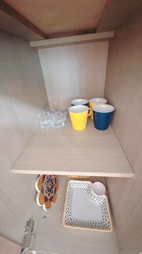 a shelf with some bowls and plates on it at Garden in Jeju 201 in Seogwipo