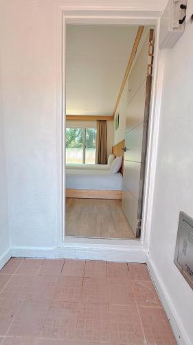 a room with a bed and a large window at Garden in Jeju 201 in Seogwipo
