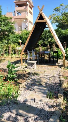 a picnic table and a bench in a park at Garden in Jeju 201 in Seogwipo