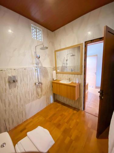 a bathroom with a shower and a sink and a mirror at Made Canggu 77 in Canggu