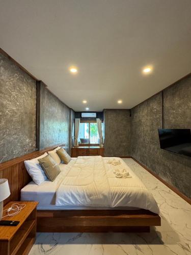 a bedroom with a large bed in a room at Libong Loft Home in Ko Libong