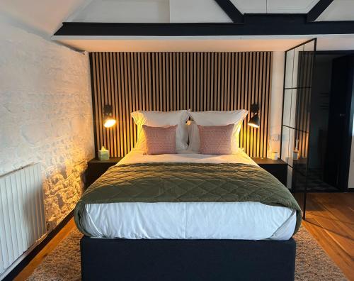 a bedroom with a large bed with pink pillows at The Studio, Arundel in Arundel