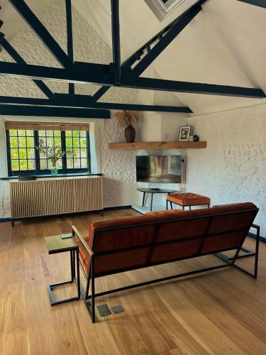 a living room with a bench and a table at The Studio, Arundel in Arundel