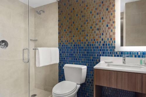a bathroom with a toilet and a sink and a shower at Courtyard by Marriott New York Manhattan/Chelsea in New York