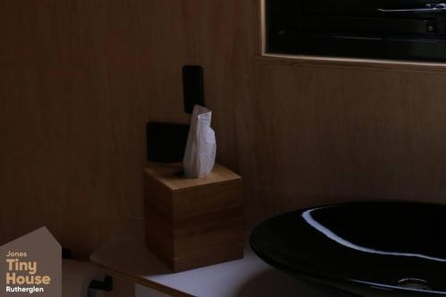 a small room with a bed and a television at Jones Winery Tiny House on the Vineyard, Rutherglen - Off Grid in Rutherglen