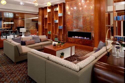 a living room with two couches and a fireplace at Raleigh Marriott Crabtree Valley in Raleigh