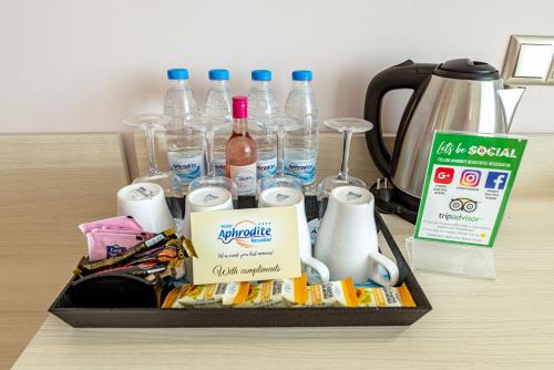 a tray of drinks and bottles of water on a table at Aphrodite Beach Hotel in Nesebar