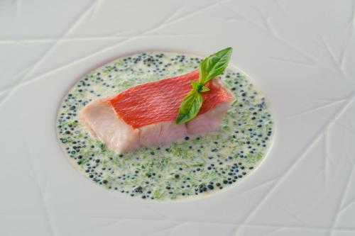 a plate of food with a piece of fish on it at Hotel Grand Bach Atami Crescendo in Atami