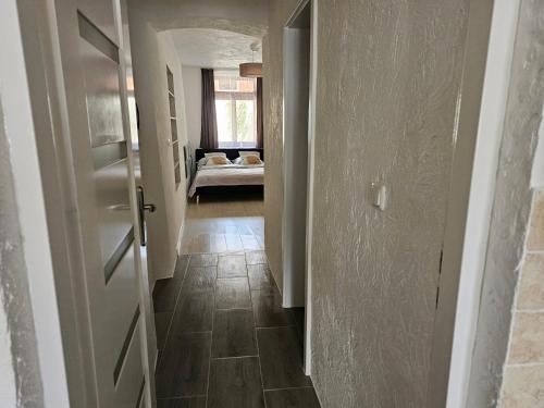 a hallway with a door and a bed in a room at Ferienwohnung Gräfin Cosel in Stolpen