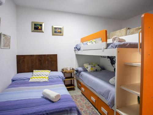 two bunk beds in a room with two beds at QUINTA do SOUTO BARCIADEMERA in Barciademera