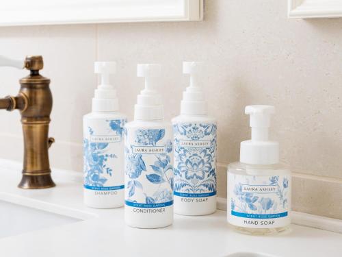 a group of four blue and white bottles on a sink at Takarazuka Hotel in Takarazuka