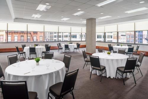 a conference room with white tables and chairs and windows at Residence Inn by Marriott New York Manhattan/Times Square in New York