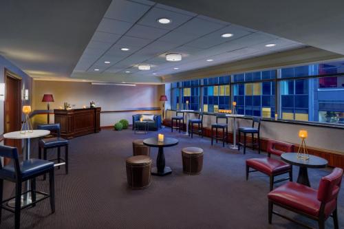 a waiting room with tables and chairs and a bar at Residence Inn by Marriott New York Manhattan/Times Square in New York