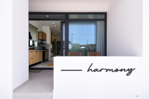 a kitchen with a counter with the word harmony on it at Gemilos Harmony in Adamas