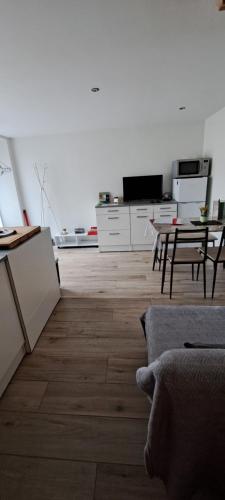 a living room with a couch and a table at Maison de bourg in Jumeaux
