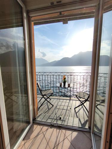 a balcony with a view of the water at On the Lake in Bellano