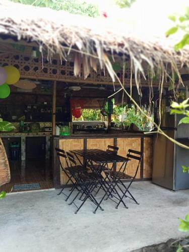 a group of chairs sitting at a bar at Weeroona Huts Homestay Pacifico in San Isidro
