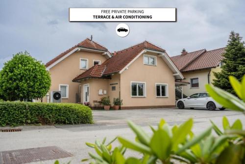 a house with a car parked in a parking lot at Diamond dream in Ptuj