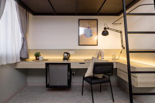 a room with a desk and a chair at Upstairs Downstairs CoLiving Bukit Bintang in Kuala Lumpur