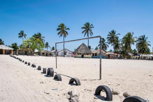 a volley ball hoop on a beach with palm trees at Mahali Zanzibar in Paje