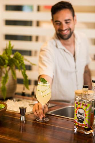 a man sitting at a bar holding a drink at Contour Hotel Katherine in Katherine