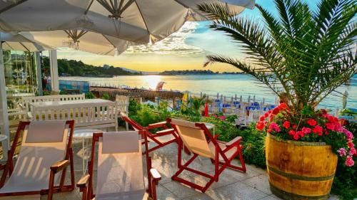 a patio with chairs and a potted plant at Aphrodite Beach Hotel in Nesebar