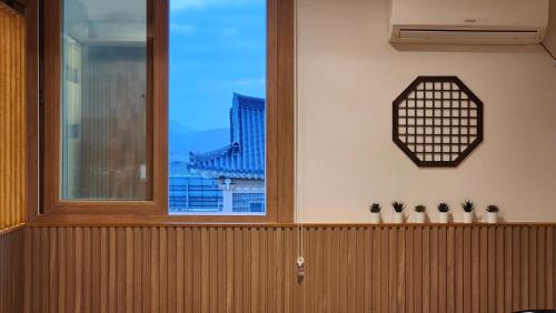 a room with a window and two potted plants at Gyeongju Hotel Check-in Bulguk in Gyeongju