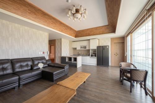 a living room with a couch and a table at Gyeongju Hotel Check-in Bulguk in Gyeongju