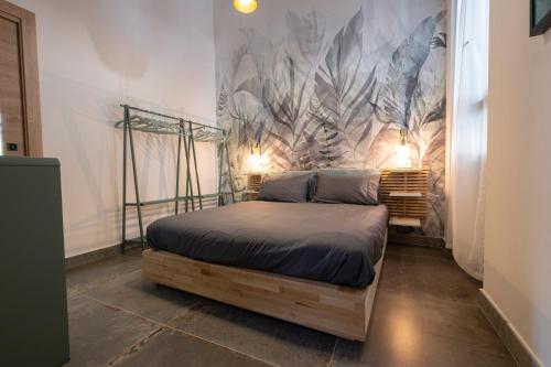 a bedroom with a bed and a wall with a mural at Vatican Boutique Apartment with large Terrace in Rome