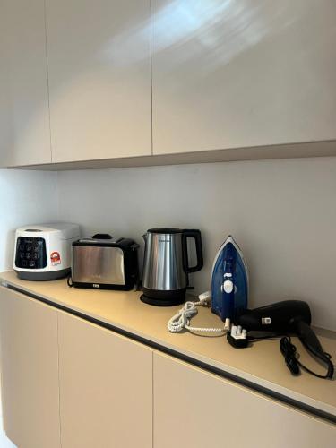 a kitchen counter with a toaster a toaster and a appliance at SS Staycation 2 Roxy Sematan Beach Apt in Sematan