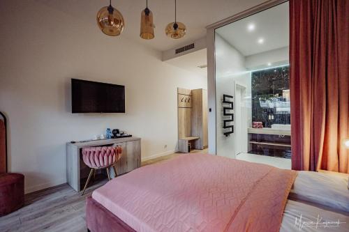 a hotel room with a bed and a television at Cristal in Ustka