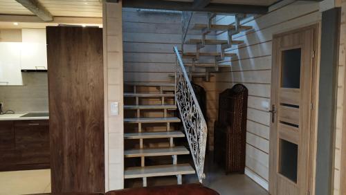 a spiral staircase in a room with wooden walls at Willa Myśliwska dom 10-osobowy ZE STREFĄ BASENOWĄ w miejscowości Chocznia NIEDALEKO ZATORU I ENERGYLANDII in Chocznia