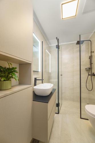 a bathroom with a sink and a shower at Villa BILA - Apartment Mari in Podstrana