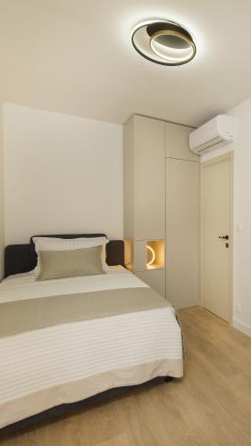 a bedroom with a large bed with a ceiling at Villa BILA - Apartment Mari in Podstrana