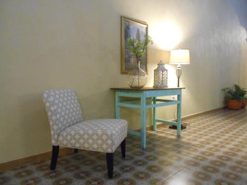 a room with a desk and a chair and a table at Hotel La Casona de Don Jorge in Colima