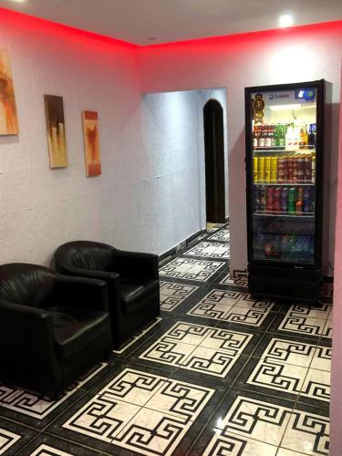 a room with a soda vending machine and a couch at Hotel itaquera Inn in Sao Paulo