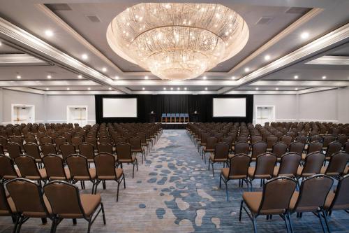 a large room with rows of chairs and a chandelier at Renaissance Newport Beach Hotel in Newport Beach