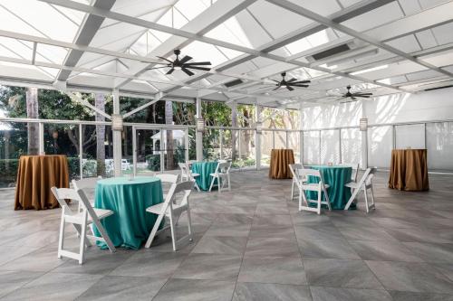a room with chairs and tables and a ceiling with windows at Renaissance Newport Beach Hotel in Newport Beach