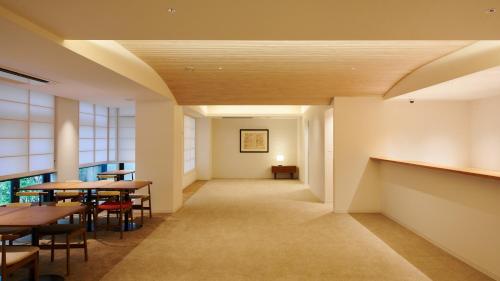a hallway with tables and chairs in a restaurant at Shin-Osaka Station Hotel in Osaka