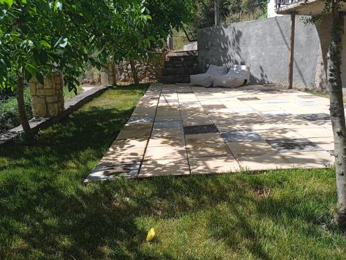 a garden with a stone walkway in the grass at Breakfast & Snacks, 2bedrooms 2bathrooms House in Kato Zachlorou