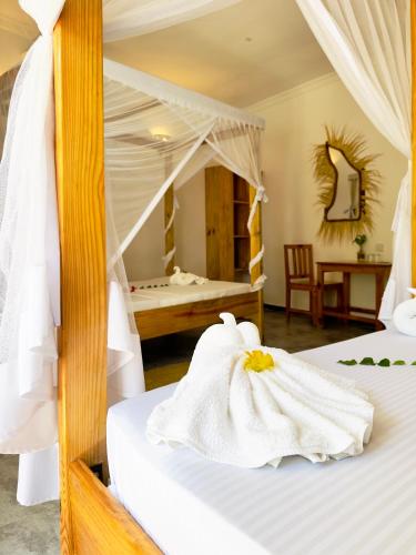 a bedroom with two beds with white towels at Hakuna Matata Boutique in Paje