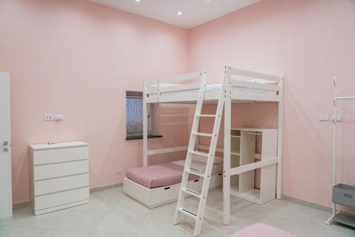 a bedroom with a bunk bed and a ladder at La Stella dei venti in Vico Equense