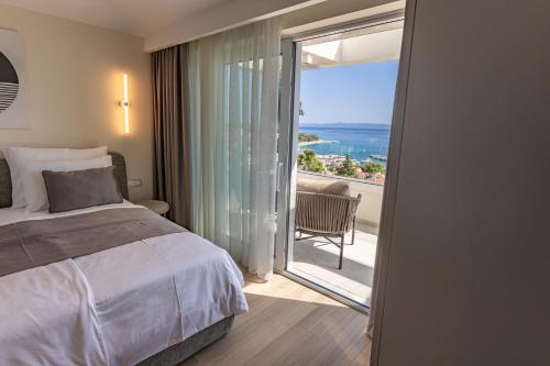 a bedroom with a bed and a view of the ocean at Exlusive Villa M -Baska Voda in Baška Voda