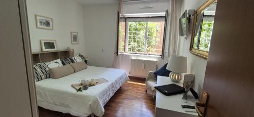a small room with a bed and a couch at EUR Fenix Apartment free parking family in Rome