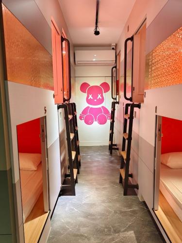 a hallway of a dorm room with a teddy bear on the wall at Jiufen Mountain Stay in Jiufen