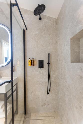 a shower stall in a bathroom with a sink and a shower at Exlusive Villa M -Baska Voda in Baška Voda