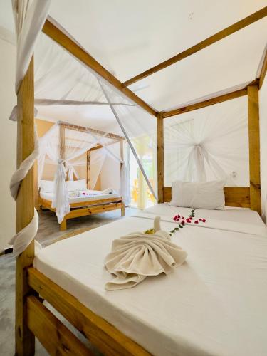 a bedroom with two beds in a tent at Hakuna Matata Boutique in Paje