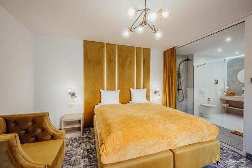 a bedroom with a large bed and a chair at Cristal in Ustka